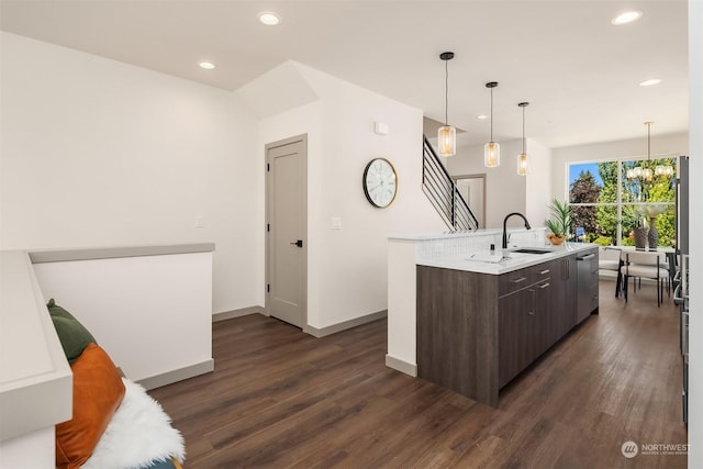 kitchen featuring dark brown cabinetry, sink, dark hardwood / wood-style flooring, and an island with sink