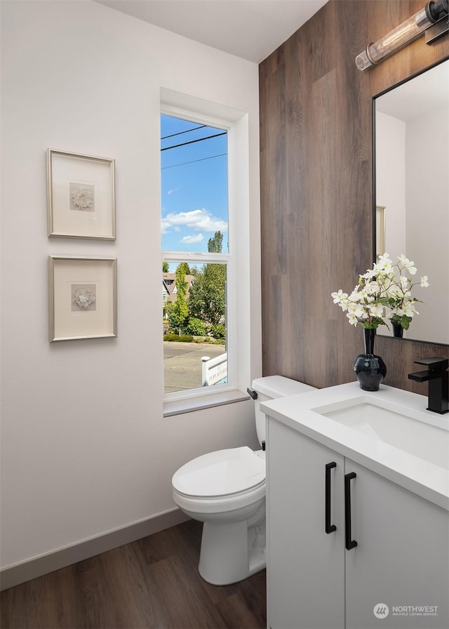 bathroom with vanity, wood-type flooring, and toilet