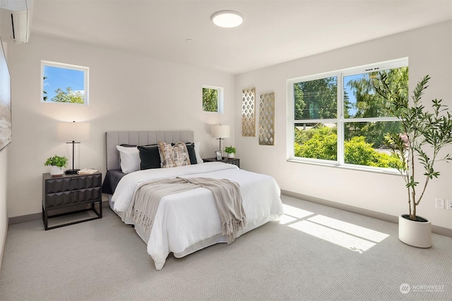 carpeted bedroom featuring multiple windows and an AC wall unit