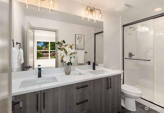 bathroom featuring vanity, toilet, and walk in shower