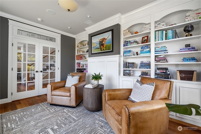 living area with french doors, ornamental molding, dark hardwood / wood-style flooring, and built in features