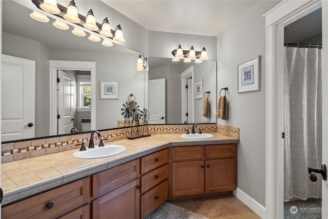 bathroom with tasteful backsplash, tile patterned floors, and vanity