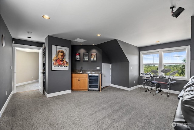 bar with sink, beverage cooler, and carpet floors