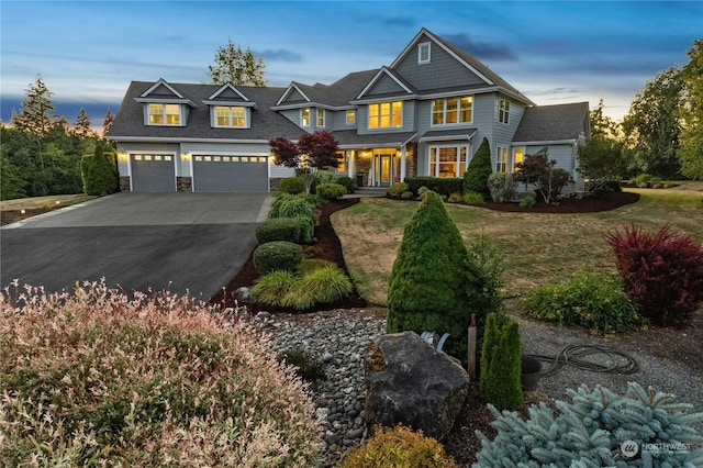 view of front of home featuring a garage and a lawn