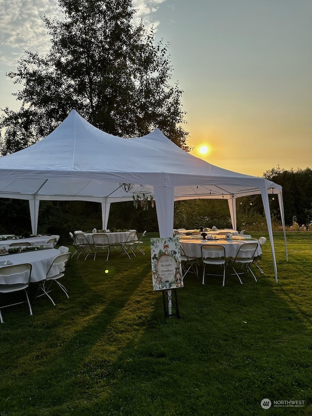 yard at dusk featuring a gazebo