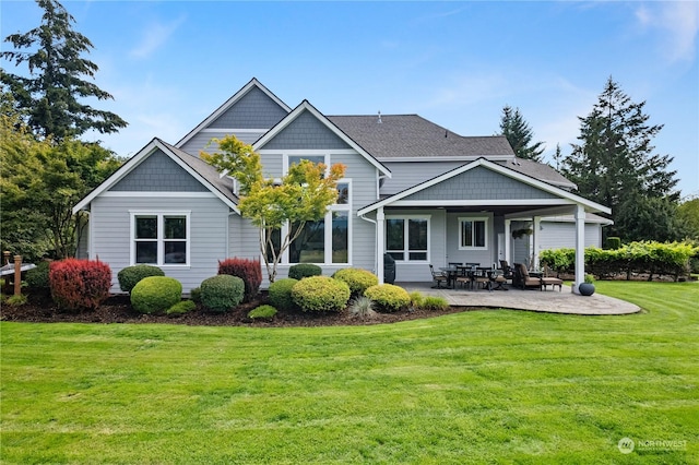 rear view of house featuring a patio and a yard