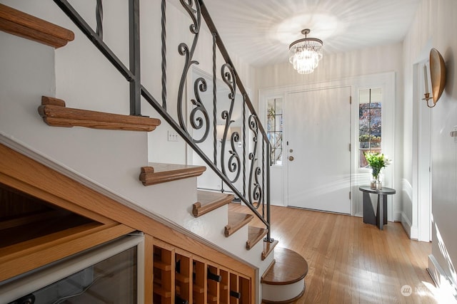 foyer entrance featuring a chandelier and light wood-type flooring