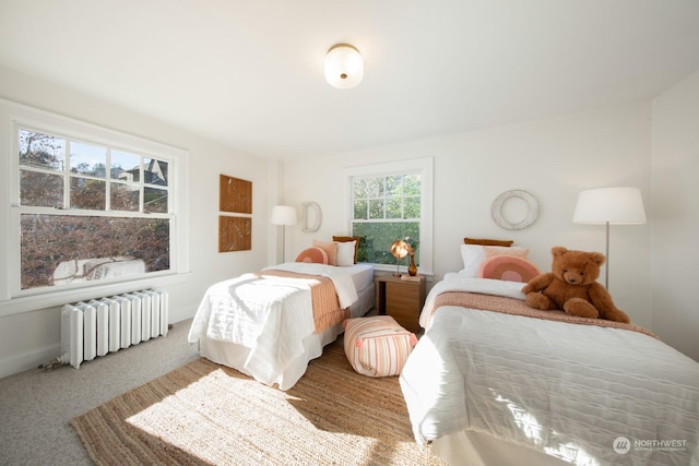 bedroom featuring radiator and carpet flooring