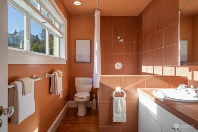 bathroom with hardwood / wood-style flooring, vanity, and toilet