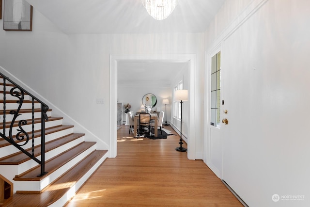 foyer featuring a notable chandelier and light hardwood / wood-style floors