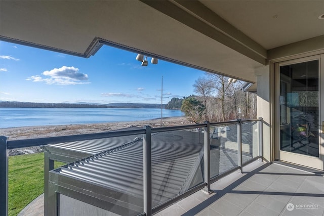 balcony featuring a water view and a view of the beach