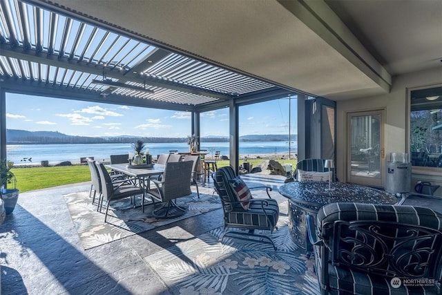 view of patio with a water and mountain view and a pergola