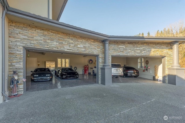 view of parking / parking lot featuring a garage