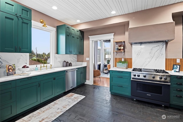 kitchen with decorative backsplash, light countertops, appliances with stainless steel finishes, and a sink