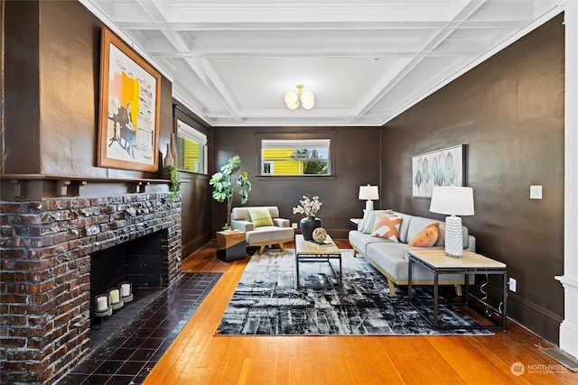 living room featuring beamed ceiling, coffered ceiling, a fireplace, and hardwood / wood-style flooring