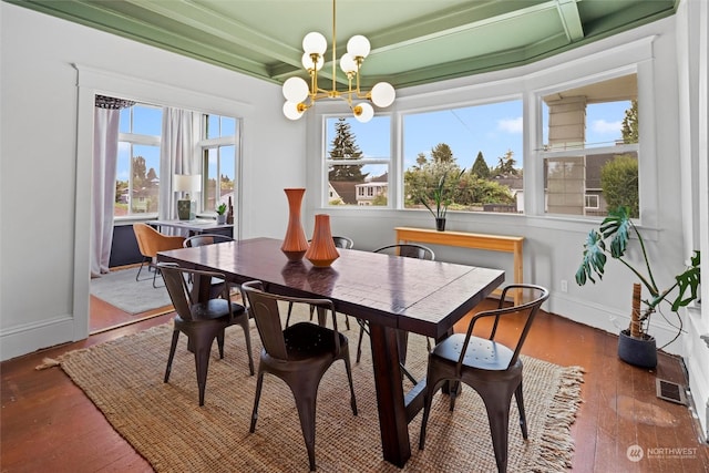 dining room with baseboards, wood-type flooring, a notable chandelier, and beamed ceiling