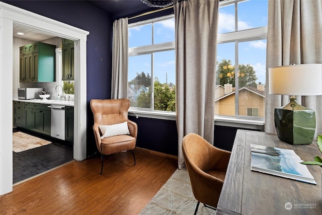 office with a sink, baseboards, and dark wood-style flooring