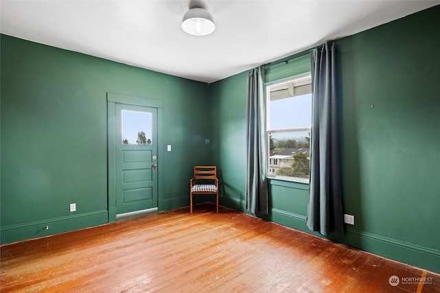 interior space featuring baseboards and wood finished floors