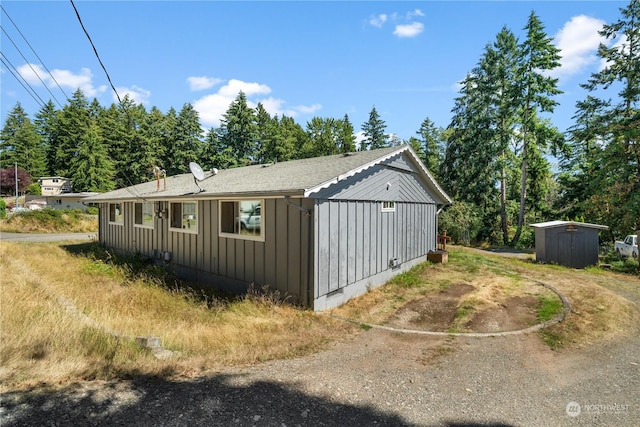 view of home's exterior with a storage shed