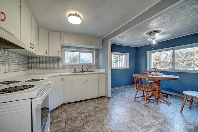 kitchen with electric stove, sink, backsplash, ornamental molding, and white cabinets