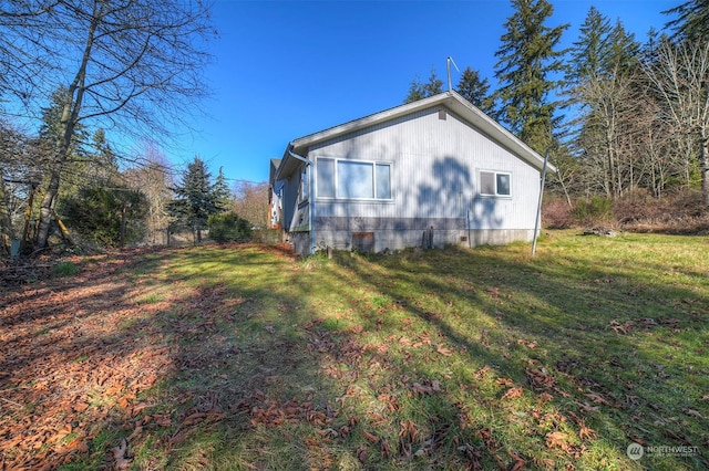view of side of property with a yard
