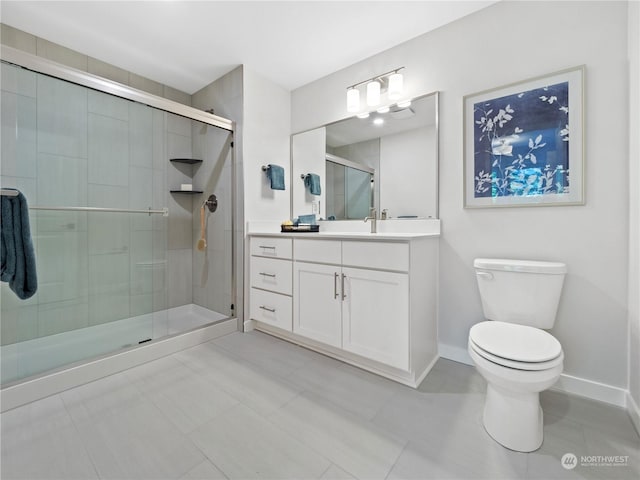 bathroom featuring vanity, toilet, and an enclosed shower