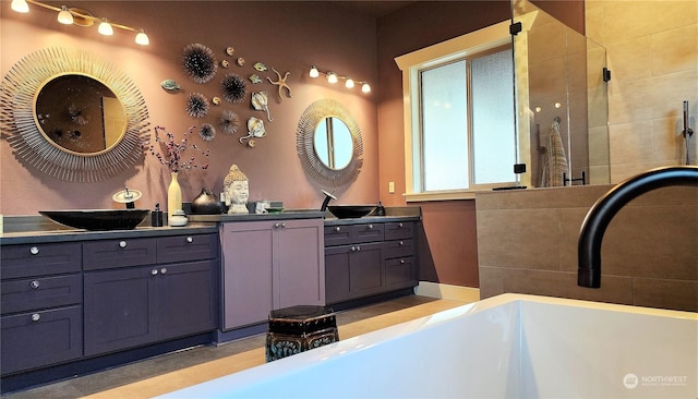 bathroom with vanity and a washtub