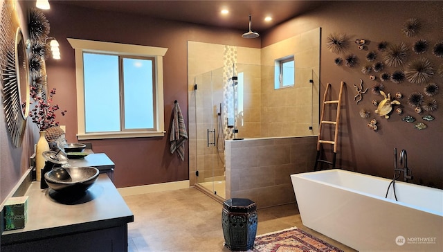 bathroom featuring plus walk in shower and vanity