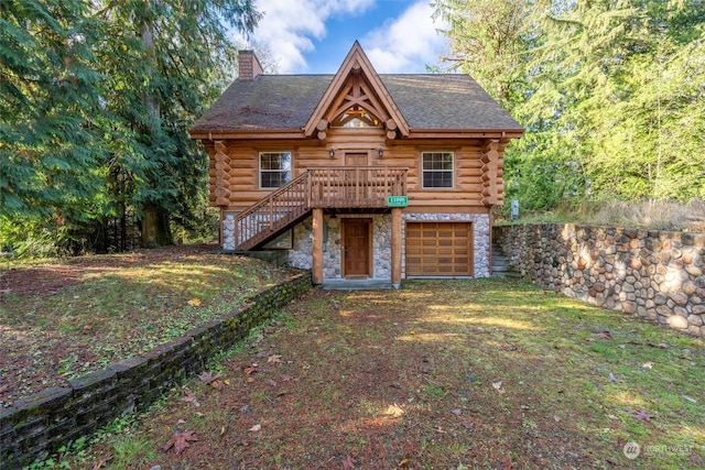 log cabin with a garage and a deck