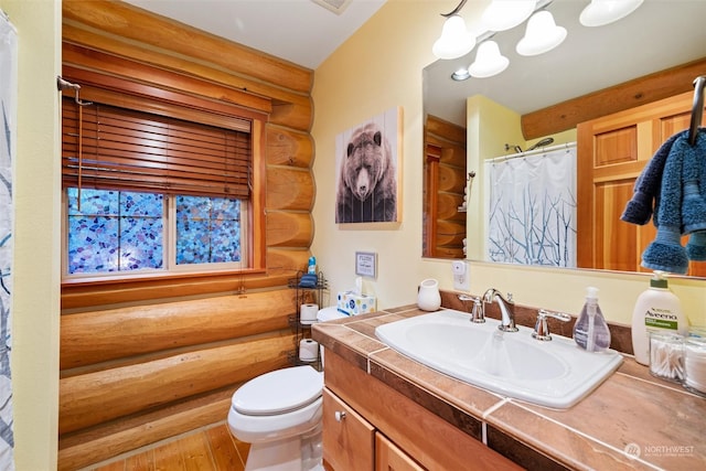 bathroom with toilet, an inviting chandelier, vanity, hardwood / wood-style flooring, and log walls