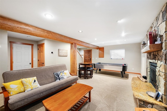 carpeted living room with beam ceiling and a fireplace