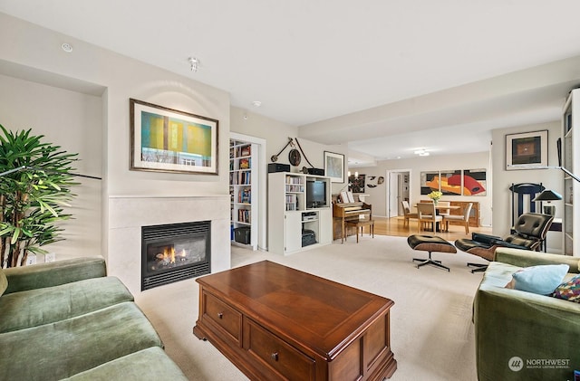 living room with a tiled fireplace