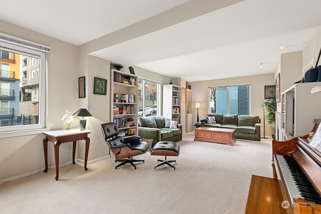 living room with plenty of natural light and light carpet