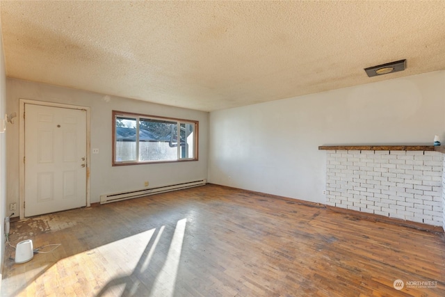 unfurnished living room with hardwood / wood-style floors, a textured ceiling, and a baseboard heating unit