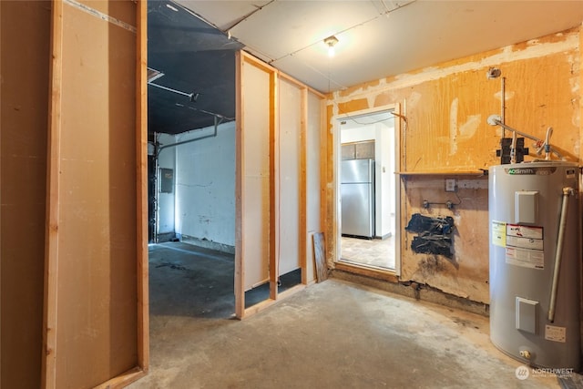 miscellaneous room featuring electric water heater, concrete floors, and electric panel