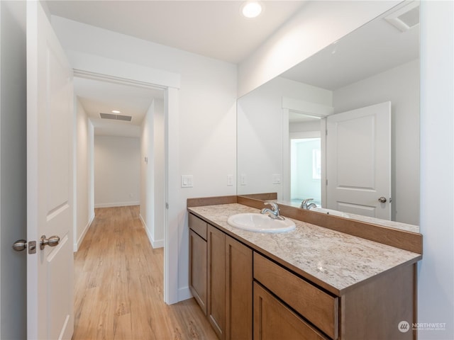 bathroom featuring vanity and hardwood / wood-style floors