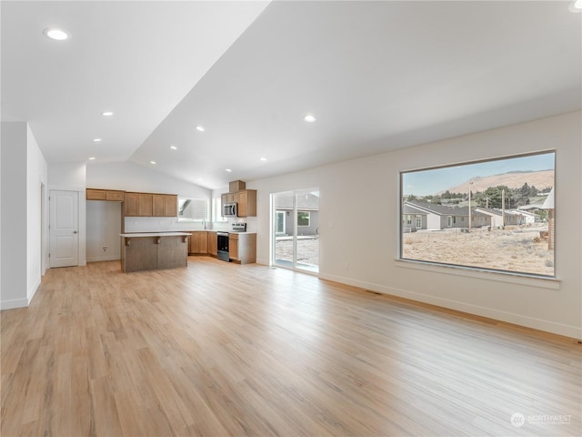 unfurnished living room featuring light hardwood / wood-style flooring and vaulted ceiling