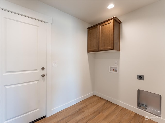 washroom with cabinets, washer hookup, hookup for an electric dryer, and light hardwood / wood-style floors