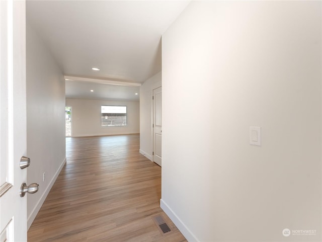 corridor with light hardwood / wood-style flooring