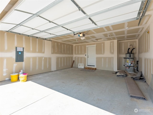 garage featuring water heater, a garage door opener, and electric panel