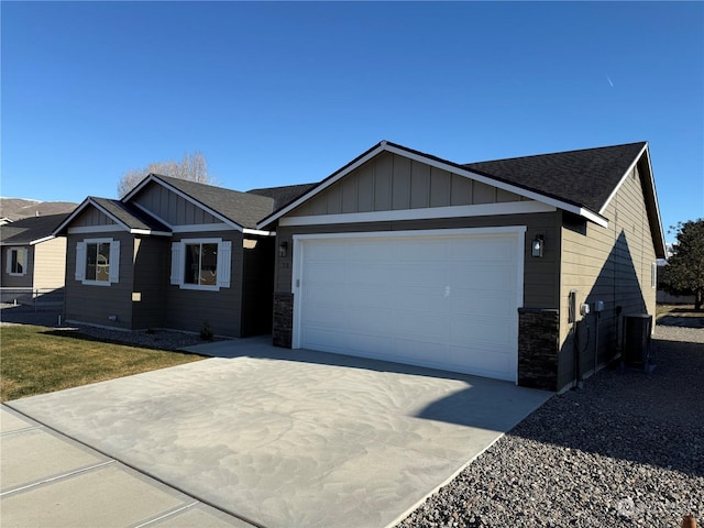 view of front of house featuring cooling unit and a garage