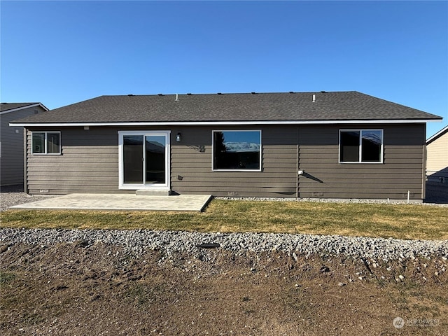 back of property featuring a patio area and a lawn