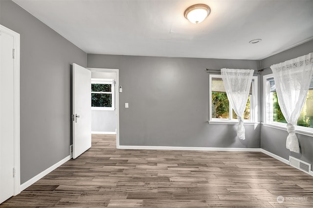 unfurnished room with dark wood-type flooring