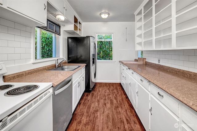 kitchen with sink, white cabinetry, appliances with stainless steel finishes, dark hardwood / wood-style floors, and decorative backsplash