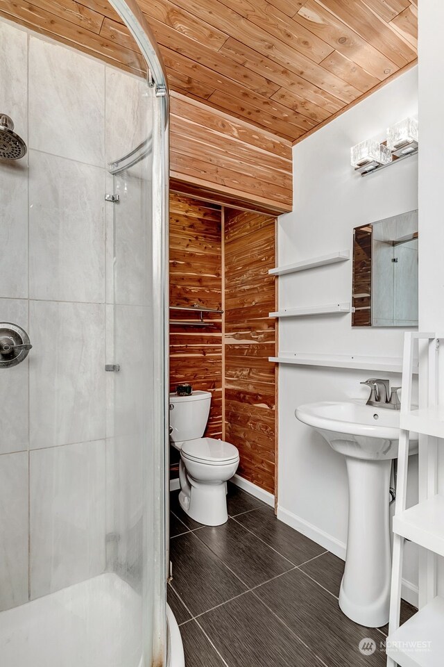 bathroom featuring wood ceiling, toilet, walk in shower, and wood walls