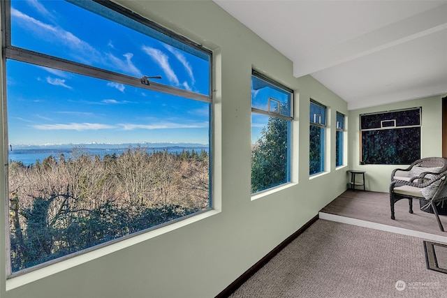 sunroom featuring lofted ceiling with beams and a water and mountain view