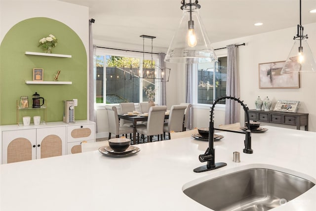 interior space featuring sink, decorative light fixtures, and a notable chandelier