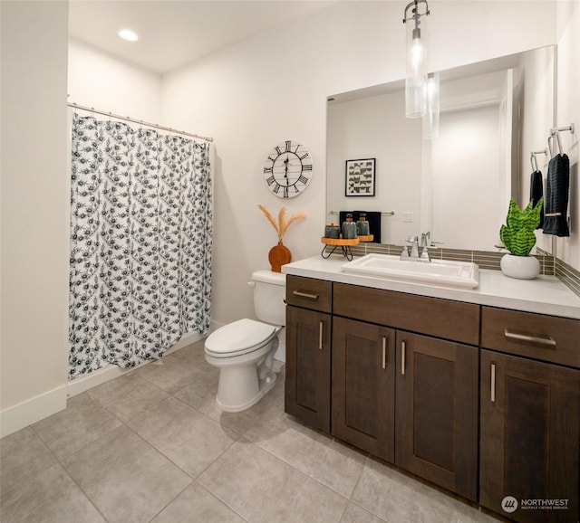 bathroom featuring tile patterned floors, vanity, and toilet