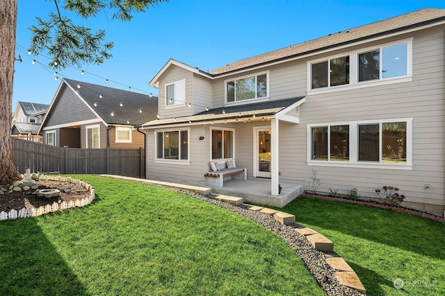 rear view of house featuring a patio and a lawn