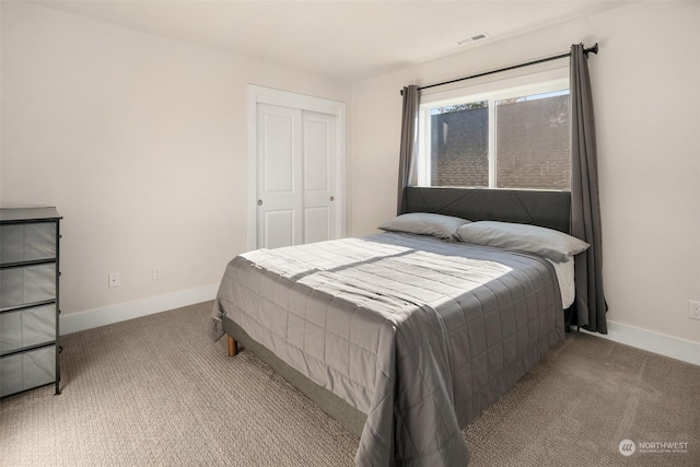 bedroom featuring light colored carpet and a closet